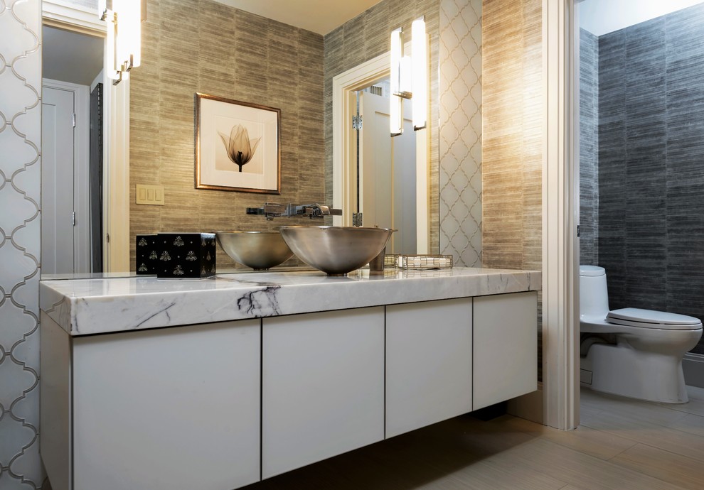 Photo of a large contemporary cloakroom in Phoenix with flat-panel cabinets, white cabinets, a one-piece toilet, white tiles, glass tiles, grey walls, porcelain flooring, a pedestal sink and marble worktops.