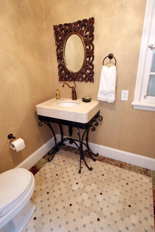 Small classic cloakroom in Charlotte with a two-piece toilet, beige tiles, beige walls, mosaic tile flooring, a wall-mounted sink and limestone worktops.