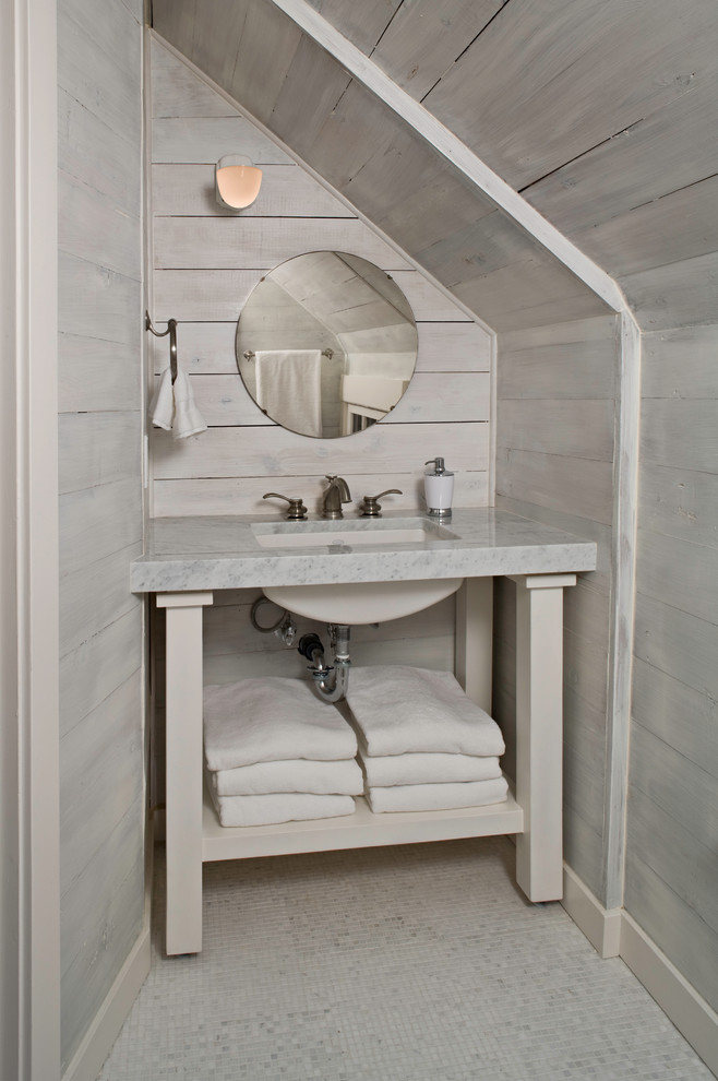 Example of a beach style powder room design in Seattle with an undermount sink, open cabinets, beige cabinets and gray countertops