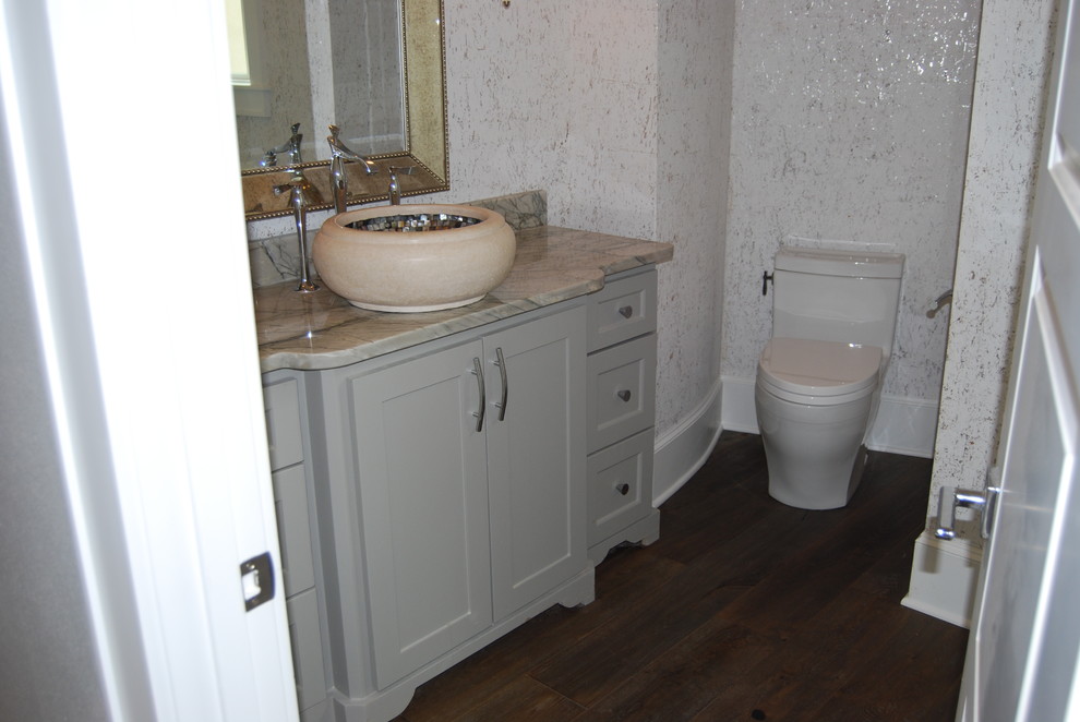 This is an example of a small traditional cloakroom in Dallas with shaker cabinets, grey cabinets, a one-piece toilet, brown walls, dark hardwood flooring, a vessel sink, marble worktops and brown floors.