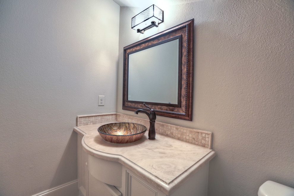 Ejemplo de aseo tradicional con lavabo sobreencimera, baldosas y/o azulejos beige y baldosas y/o azulejos de piedra
