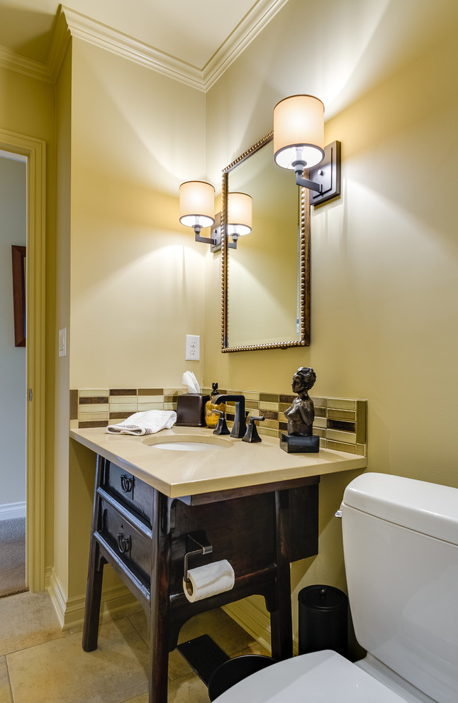 マイアミにあるトランジショナルスタイルのおしゃれなトイレ・洗面所 (アンダーカウンター洗面器、家具調キャビネット、濃色木目調キャビネット、分離型トイレ、マルチカラーのタイル) の写真