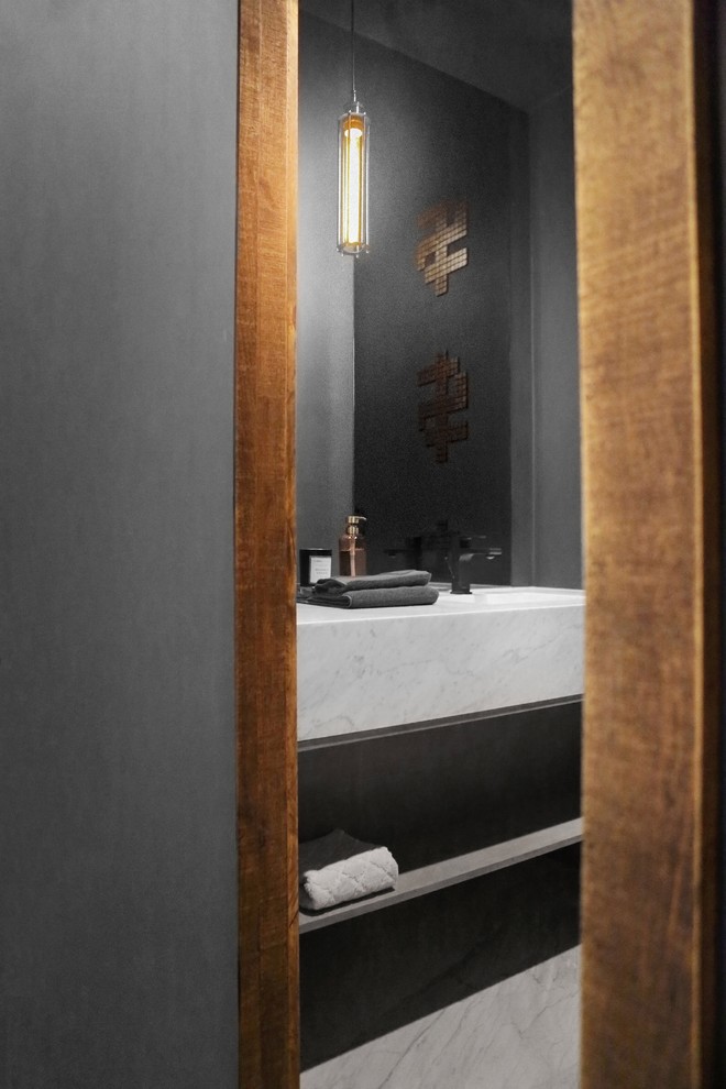 This is an example of a small contemporary cloakroom in Toronto with open cabinets, black walls, marble flooring, a submerged sink, marble worktops and white floors.