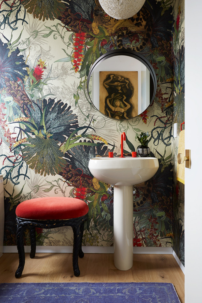 Inspiration for a medium sized bohemian cloakroom in Los Angeles with light hardwood flooring, a pedestal sink and wallpapered walls.