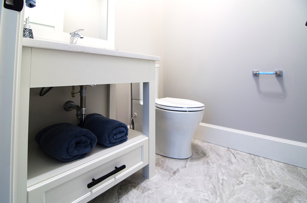Small traditional cloakroom in Other with open cabinets, white cabinets, a two-piece toilet, grey walls, a submerged sink, marble worktops, grey floors and white worktops.