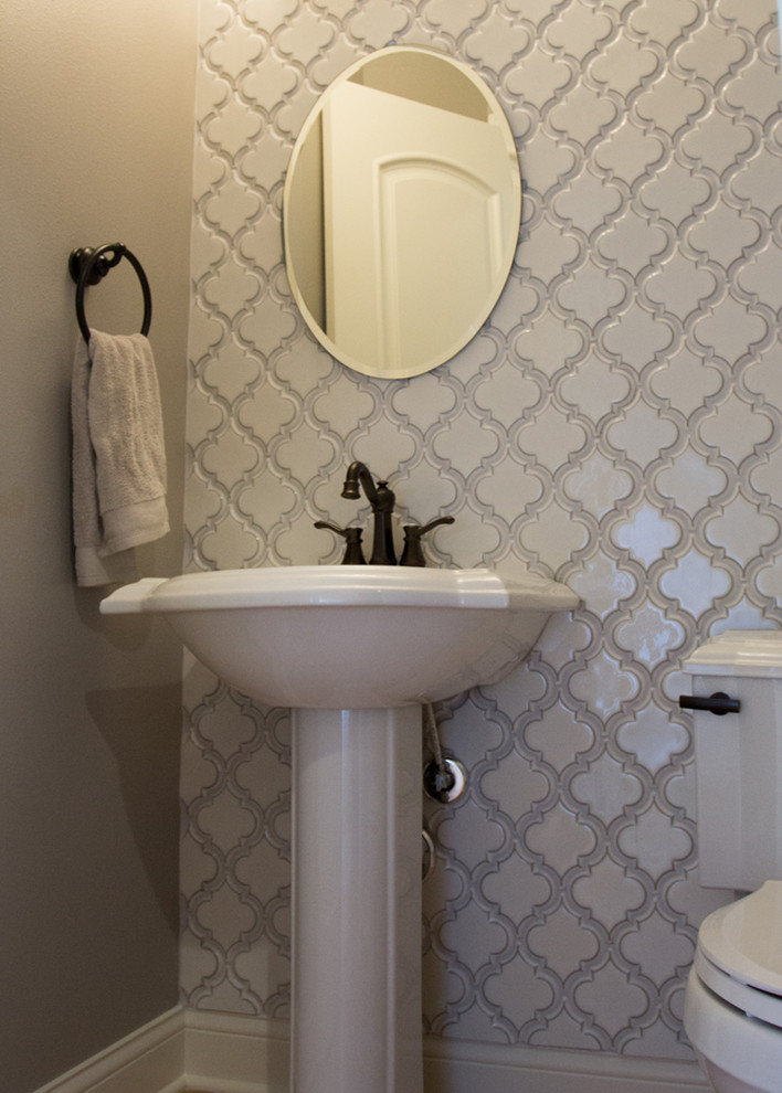 Inspiration for a small classic cloakroom in Milwaukee with grey tiles and grey walls.