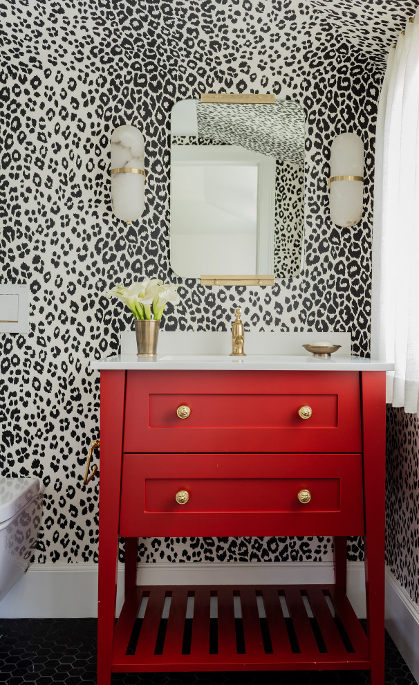 Example of a mid-sized classic white tile and ceramic tile ceramic tile, black floor and wallpaper powder room design in Boston with an undermount sink, marble countertops, white countertops, shaker cabinets, red cabinets, multicolored walls and a freestanding vanity