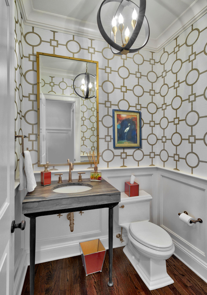 This is an example of a small traditional cloakroom in New York with freestanding cabinets, a two-piece toilet, grey tiles, white tiles, porcelain tiles, white walls, dark hardwood flooring, solid surface worktops, a submerged sink, brown floors and grey worktops.