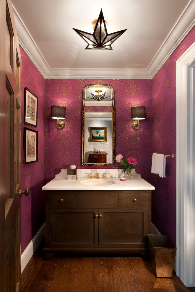 Example of a classic dark wood floor and brown floor powder room design in Milwaukee with dark wood cabinets, purple walls and recessed-panel cabinets