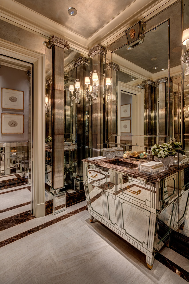 Immagine di un bagno di servizio chic con consolle stile comò, piastrelle a specchio, pavimento in marmo, lavabo sottopiano, top in marmo, pavimento grigio e top marrone