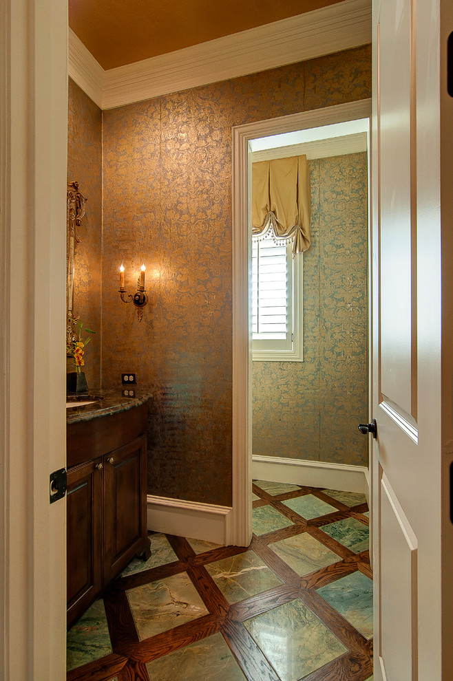 This is an example of a traditional cloakroom in Dallas with dark wood cabinets and multi-coloured walls.