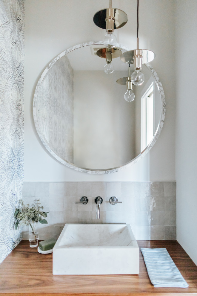 Inspiration for a small transitional gray tile powder room remodel in Portland Maine with white walls, a vessel sink, wood countertops and beige countertops