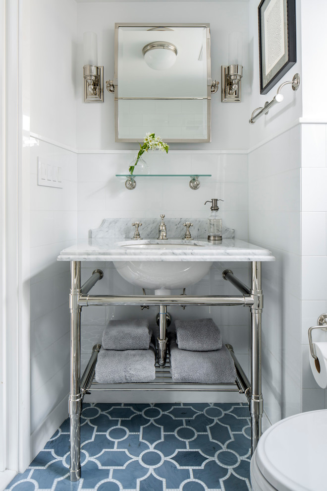 Идея дизайна: маленький туалет в классическом стиле с унитазом-моноблоком, белой плиткой, керамической плиткой, белыми стенами, полом из мозаичной плитки, консольной раковиной и синим полом для на участке и в саду