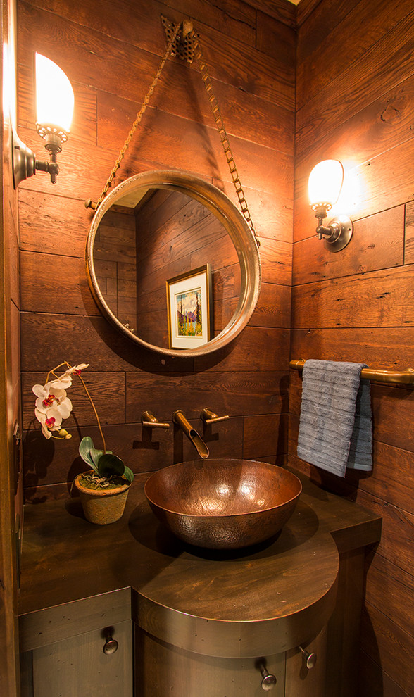 Photo of a small rustic cloakroom in Calgary with freestanding cabinets and a vessel sink.