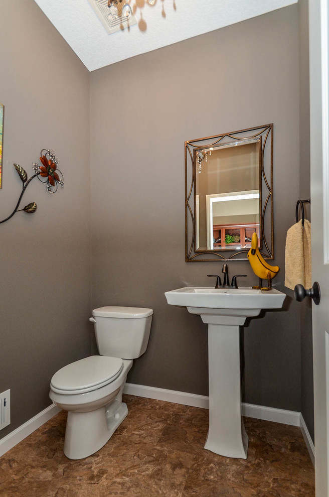На фото: туалет в стиле неоклассика (современная классика) с раковиной с пьедесталом и коричневыми стенами