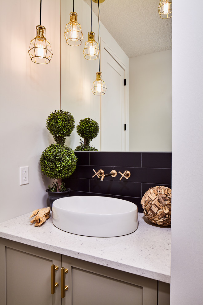 Example of a mid-sized trendy gray tile and ceramic tile ceramic tile and gray floor powder room design in Calgary with shaker cabinets, gray cabinets, a two-piece toilet, white walls, a vessel sink, quartz countertops and white countertops