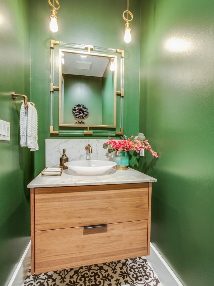Design ideas for a small modern cloakroom in Houston with flat-panel cabinets, light wood cabinets, a one-piece toilet, green tiles, green walls, cement flooring, a pedestal sink, quartz worktops, black floors, beige worktops and stone slabs.