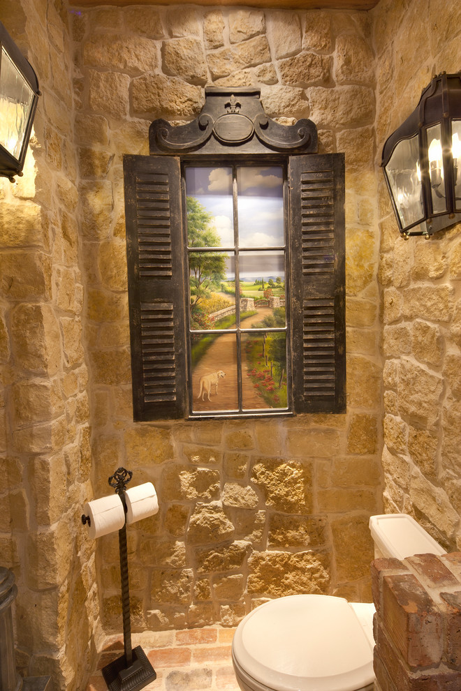 Mid-sized mountain style beige tile and stone tile brick floor powder room photo in Dallas with open cabinets, light wood cabinets, a two-piece toilet, beige walls, a vessel sink and wood countertops