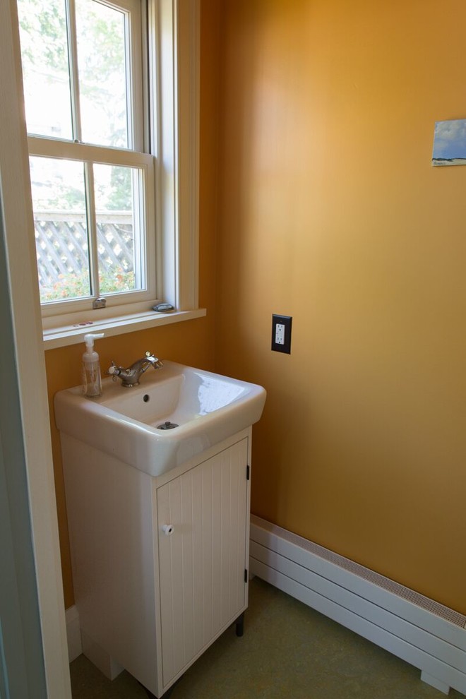 Design ideas for a small classic cloakroom in Philadelphia with flat-panel cabinets, white cabinets, a two-piece toilet, yellow walls and an integrated sink.