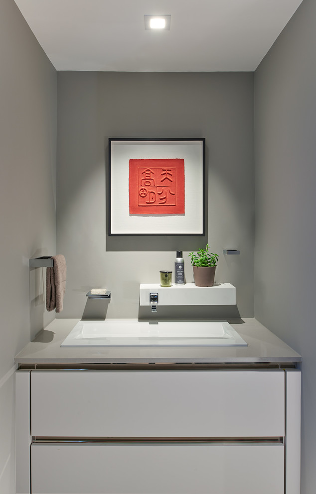 Inspiration for a contemporary cloakroom in DC Metro with flat-panel cabinets, white cabinets and grey walls.