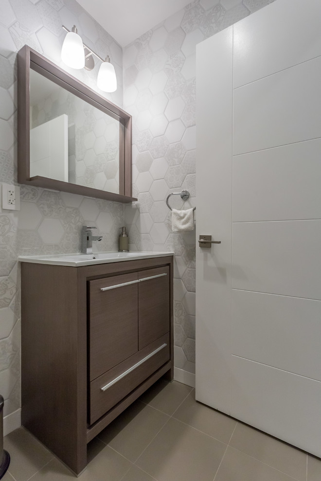 Powder room - small contemporary porcelain tile porcelain tile powder room idea in Los Angeles with a two-piece toilet, gray walls, flat-panel cabinets, an integrated sink and dark wood cabinets