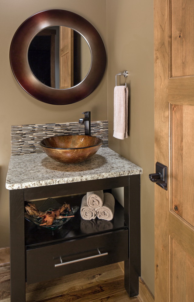 Inspiration for a traditional cloakroom in Omaha with a vessel sink.