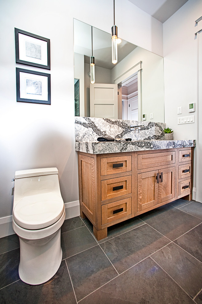 Small mountain style black and white tile gray floor powder room photo in Other with shaker cabinets, light wood cabinets, a one-piece toilet, gray walls, an undermount sink and quartz countertops