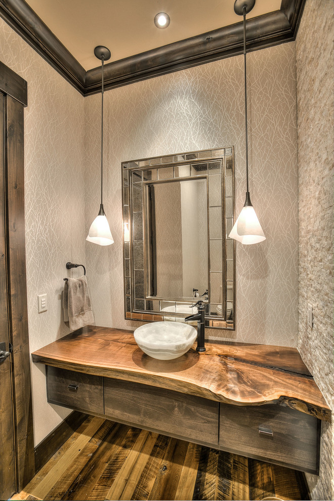 Medium sized rustic cloakroom in Denver with flat-panel cabinets, dark wood cabinets, beige tiles, stone tiles, beige walls, medium hardwood flooring, a vessel sink, wooden worktops and brown worktops.