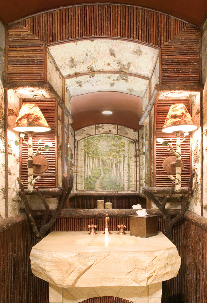 Esempio di un bagno di servizio rustico con lavabo integrato