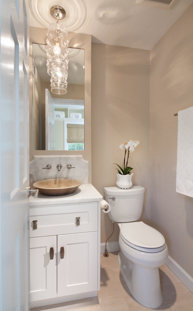 Design ideas for a beach style cloakroom in DC Metro with marble worktops, a vessel sink, shaker cabinets, white cabinets, a two-piece toilet, beige walls and white worktops.