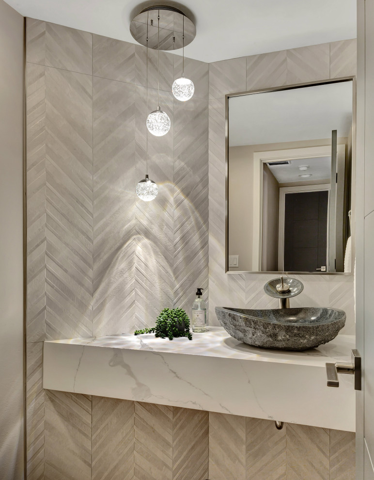 Example of a small minimalist gray tile and porcelain tile light wood floor and gray floor powder room design in Seattle with a one-piece toilet, gray walls, a vessel sink, quartz countertops and white countertops