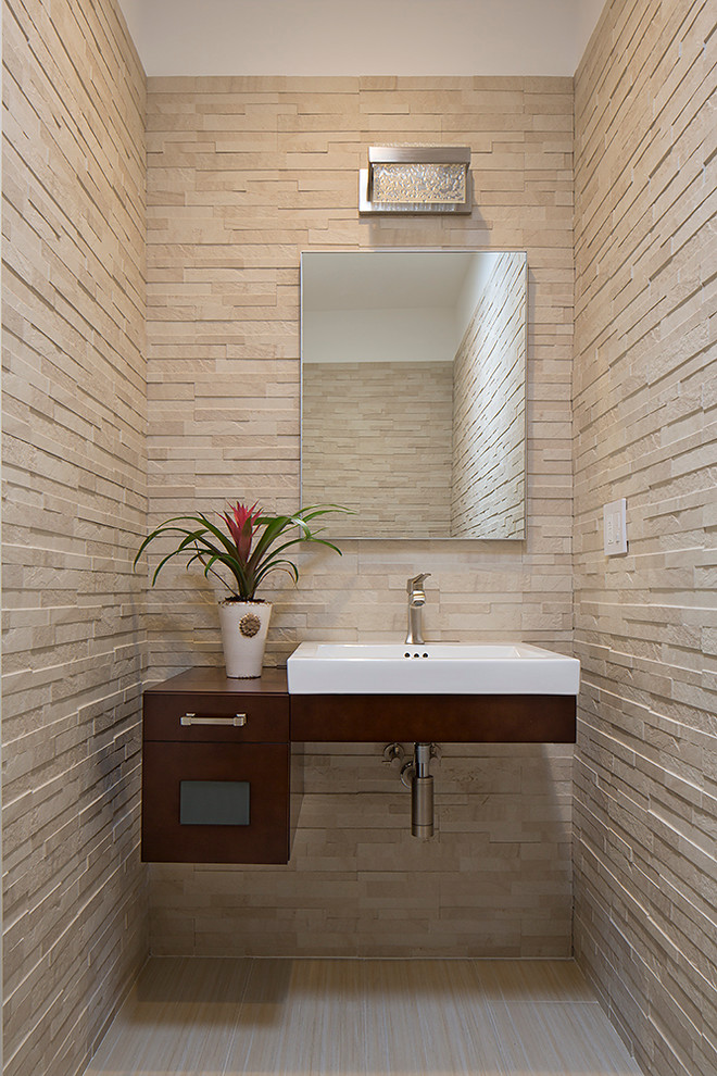 Inspiration for a contemporary cloakroom in San Francisco with a vessel sink, freestanding cabinets, dark wood cabinets and beige tiles.