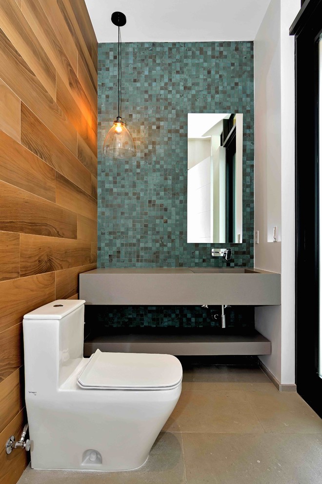 This is an example of a small contemporary cloakroom in Miami with open cabinets, grey cabinets, a one-piece toilet, multi-coloured tiles, ceramic tiles, blue walls, limestone flooring, an integrated sink and engineered stone worktops.