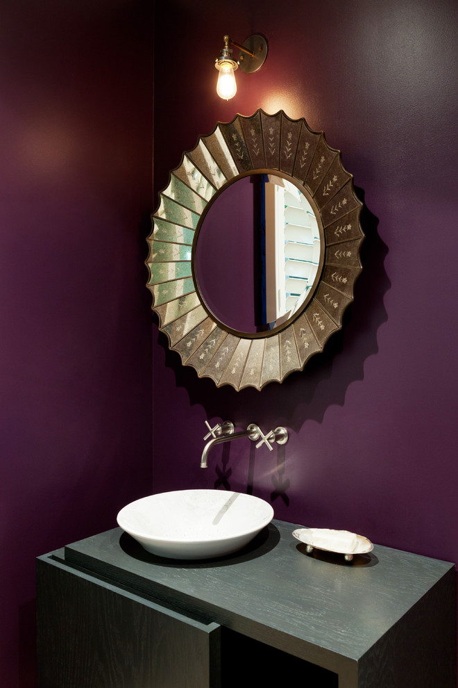 Inspiration for a mid-sized contemporary light wood floor powder room remodel in Los Angeles with flat-panel cabinets, dark wood cabinets, purple walls and wood countertops