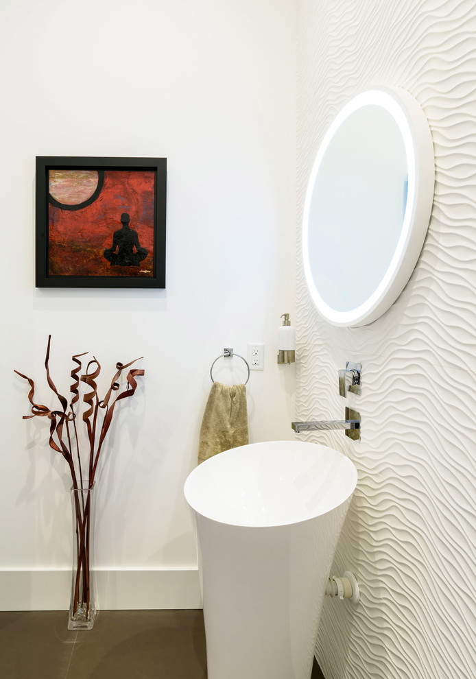 ジャクソンビルにあるラグジュアリーな中くらいなアジアンスタイルのおしゃれなトイレ・洗面所 (白いキャビネット、一体型トイレ	、白いタイル、セラミックタイル、白い壁、磁器タイルの床、ペデスタルシンク、グレーの床) の写真