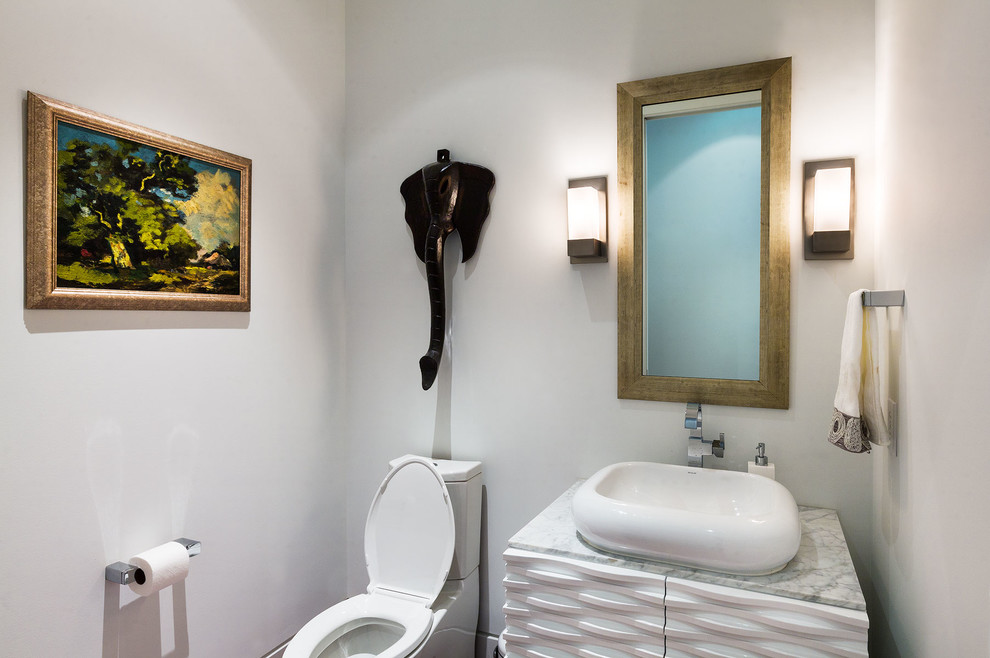 Powder room - contemporary powder room idea in Houston with a vessel sink, white cabinets and a two-piece toilet