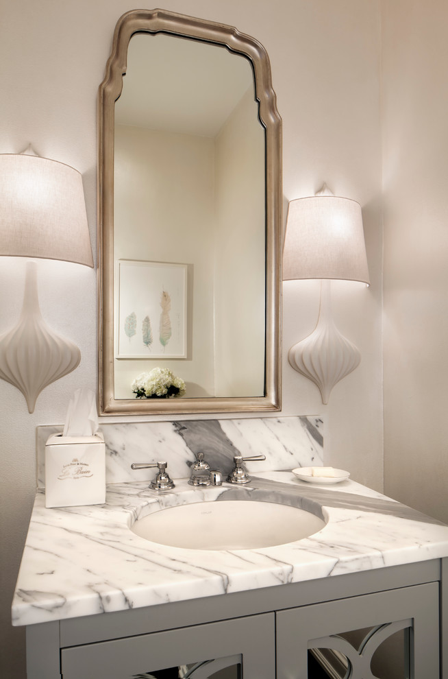 Esempio di un bagno di servizio tradizionale con lavabo sottopiano, ante grigie, pareti beige, top in marmo e top bianco