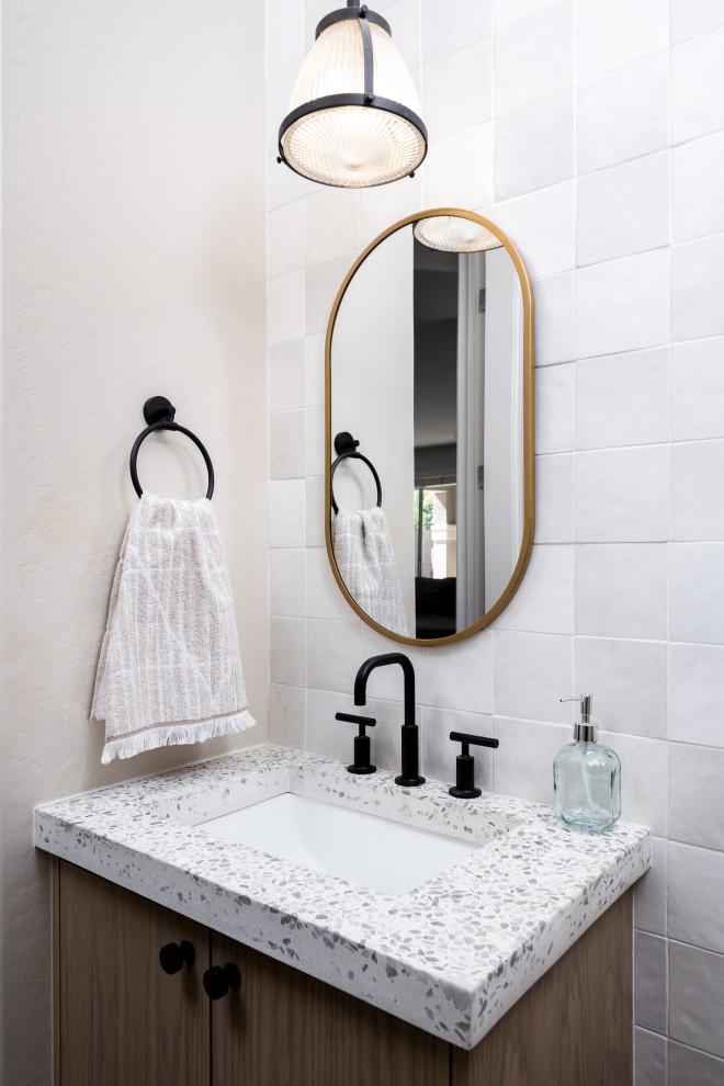Transitional white tile powder room photo in Phoenix with flat-panel cabinets, medium tone wood cabinets, white walls, an undermount sink and white countertops