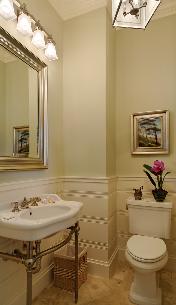 Example of a small beach style travertine floor powder room design in Seattle with a pedestal sink, a two-piece toilet and green walls