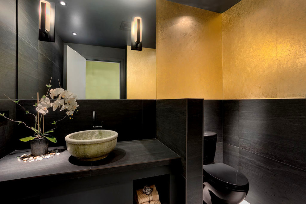 Medium sized modern cloakroom in Seattle with black cabinets, black tiles, porcelain tiles, multi-coloured walls, porcelain flooring, a vessel sink, tiled worktops, black floors, black worktops, a floating vanity unit and wallpapered walls.