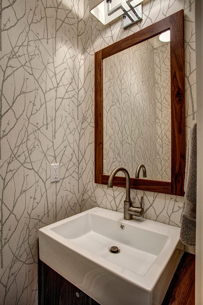 Idée de décoration pour un petit WC et toilettes tradition en bois foncé avec un mur gris, un placard à porte plane et une vasque.