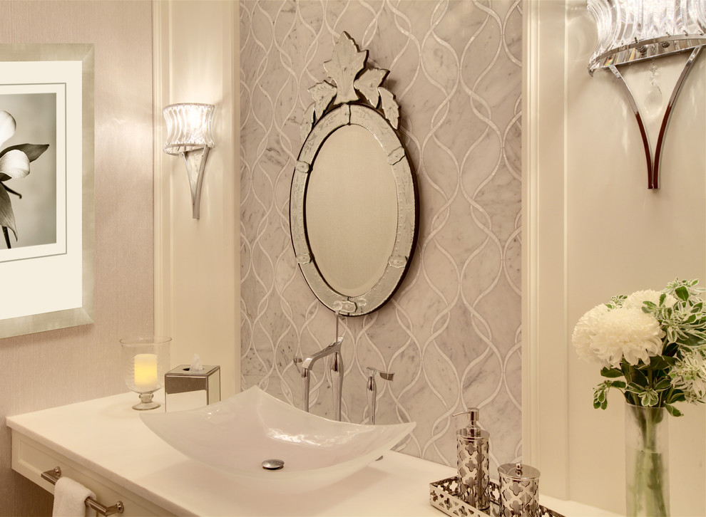 Example of a small transitional gray tile and stone tile powder room design in Phoenix with a vessel sink, white cabinets, marble countertops and gray walls