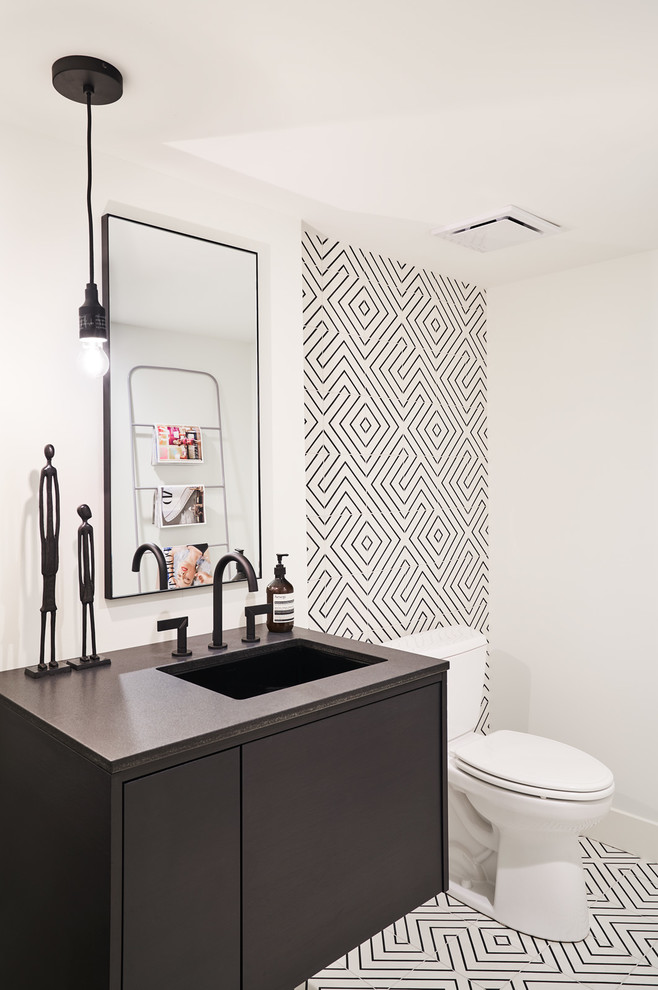 Inspiration for a contemporary cloakroom in Kansas City with flat-panel cabinets, black cabinets, black and white tiles, white walls, a submerged sink, white floors and black worktops.