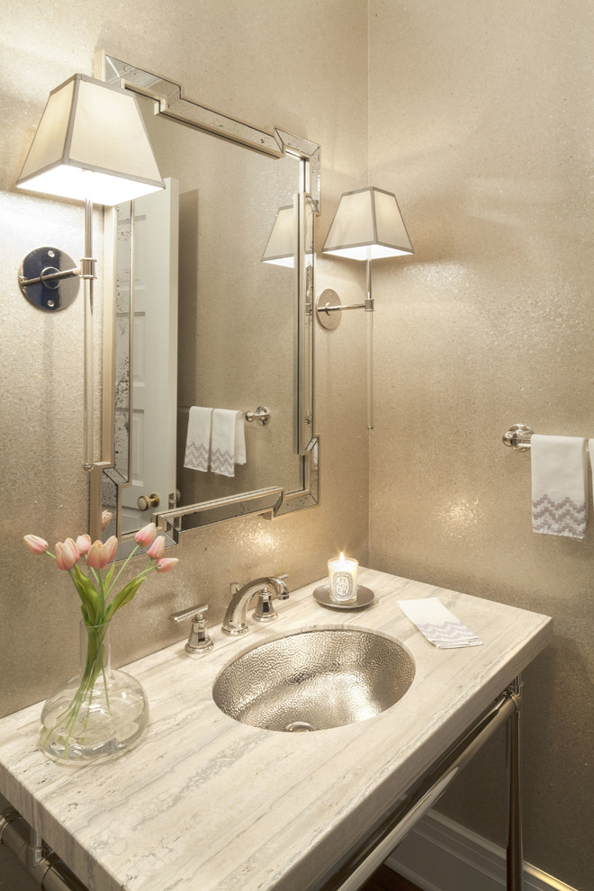 Inspiration for a small transitional powder room remodel in Dallas with an undermount sink, gray walls, limestone countertops and beige countertops