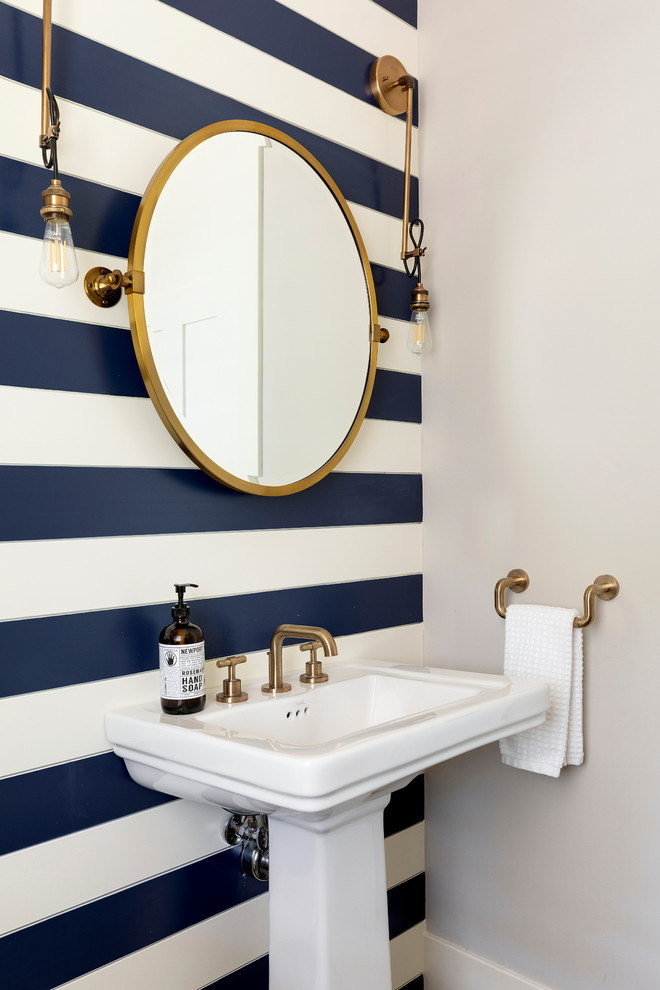 Example of a beach style powder room design in Minneapolis with multicolored walls and a pedestal sink