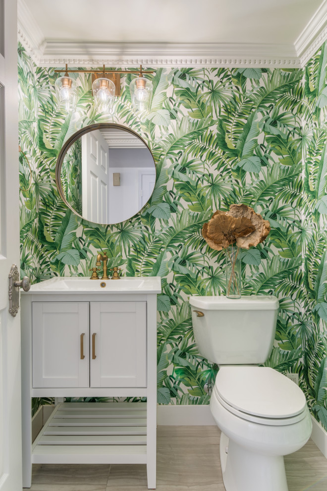 Inspiration for a classic cloakroom in Los Angeles with shaker cabinets, white cabinets, porcelain flooring, beige floors, white worktops, a two-piece toilet, green walls, a console sink, a freestanding vanity unit and wallpapered walls.