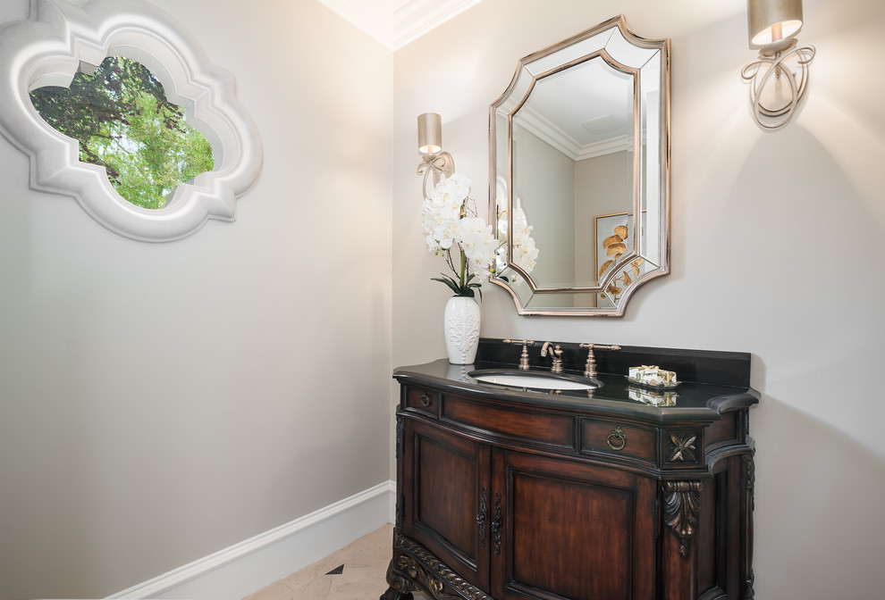This is an example of a small traditional cloakroom in Sacramento with brown cabinets, marble flooring, an integrated sink, granite worktops and beige floors.
