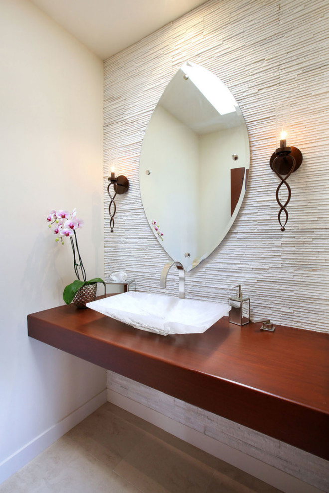 This is an example of a contemporary cloakroom in Orange County with white tiles, white walls, a vessel sink, wooden worktops, brown worktops, limestone flooring, open cabinets and stone tiles.