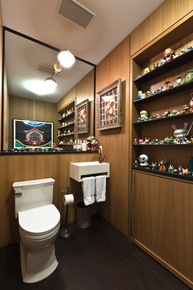 Photo of a medium sized contemporary cloakroom in New York with a wall-mounted sink, a one-piece toilet and white cabinets.