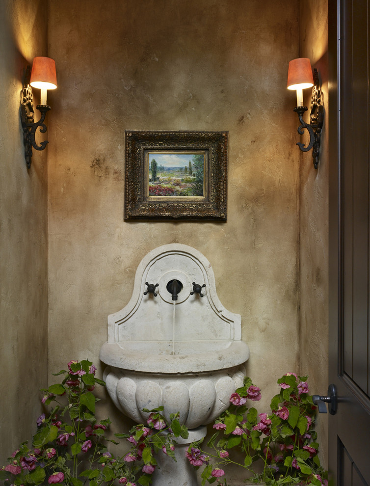Powder room - small mediterranean powder room idea in Denver with beige walls and an integrated sink